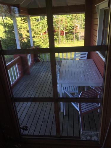 a porch with a table and chairs on it at Metsorinne in Kotila