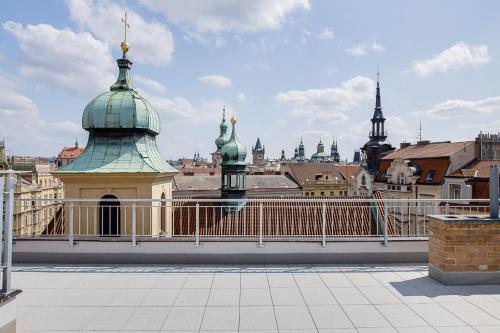 a bridge with green domes on top of a city at Gold Art Apartments in Prague