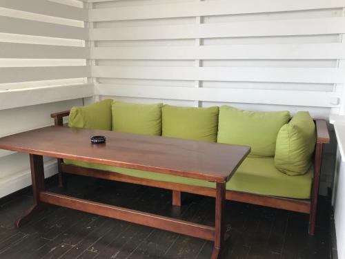a green couch with a wooden table in a room at Shpinat in Odesa