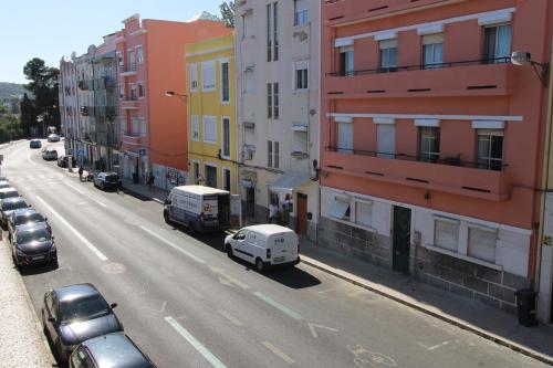 a view of a city street with cars and buildings at Sete Rios, Near Zoo Lisboa/ free Wifi in Lisbon