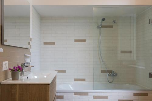 a bathroom with a shower and a tub and a sink at Villa Mallandrino in Mondello