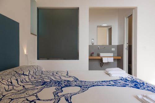 a bedroom with a bed with a large screen on the wall at Villa Mallandrino in Mondello