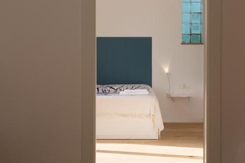 a bedroom with a bed with a blue wall at Villa Mallandrino in Mondello