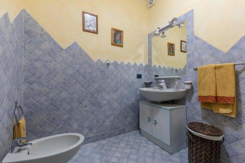 a bathroom with a sink and a toilet and a sink at Villa Iris with Pool in Baja Sardinia
