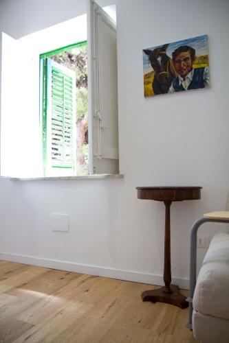 a living room with a window and a table at Villa Mallandrino in Mondello