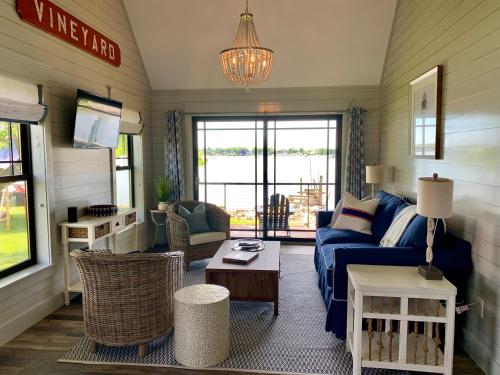 a living room with a blue couch and a table at Harbor View Landing in Mystic