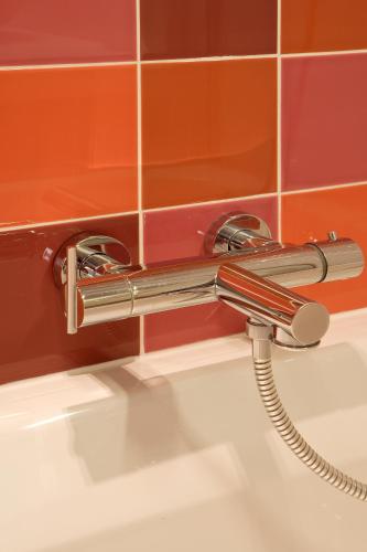 a faucet over a sink in a bathroom at Parkhotel Roeselare in Roeselare