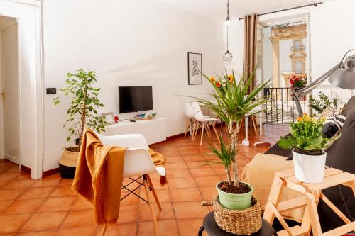 a living room filled with lots of potted plants at I Balconi di San Domenico in Palermo