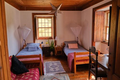 a bedroom with two beds and a star on the wall at A Charming , Traditional Cottage at Quinta da Ribeira in Vila Nova de Poiares