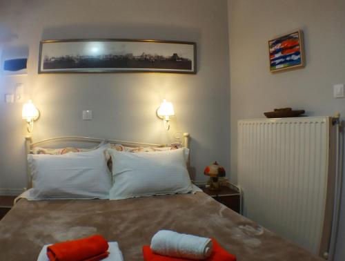 a bedroom with a bed with two towels on it at Kalokenti Studios in Aegina Town
