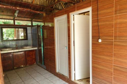 an open door to a bathroom in a house at El Portal De Champey in Lanquín