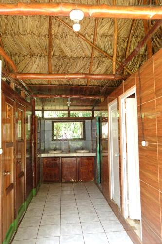 a room with a wooden floor and wooden walls at El Portal De Champey in Lanquín