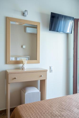 a bedroom with a dressing table and a mirror at Kavadias Apartments in Vasiliki