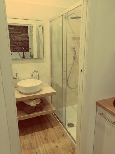 a bathroom with a sink and a glass shower at Studio apartman Villa Gianna in Lovran