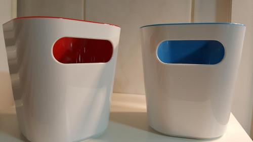 two white vases sitting on top of a table at NA OFF in Radenci