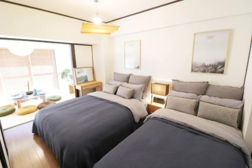 Postel nebo postele na pokoji v ubytování Osaka Mainichi Building Vacation STAY 242