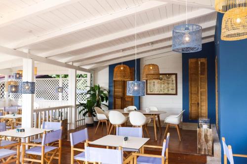 a dining room with tables and chairs and blue walls at Vallicella Glamping Resort in Scarlino