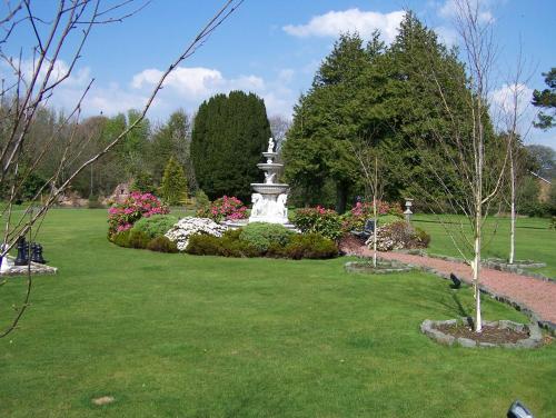 a park with a statue in the middle of a lawn at The Ennerdale Country House Hotel ‘A Bespoke Hotel’ in Cleator