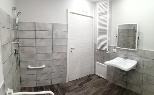 a white bathroom with a sink and a shower at Opera Boutique Rooms in Monreale