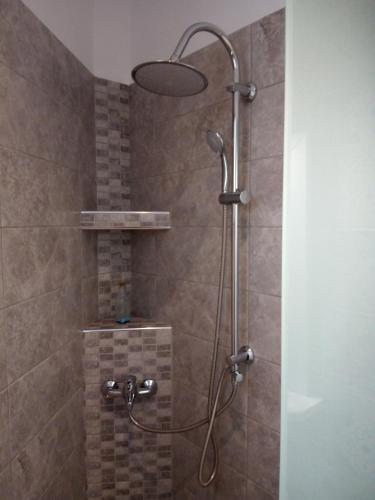 a shower with a shower head in a bathroom at Evel House in Skala Kallirakhis
