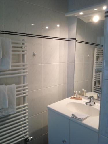 a bathroom with a sink and a mirror at Hotel Lemmer in Lemmer