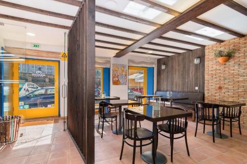 a dining room with wooden tables and chairs at Miragaia House in Porto