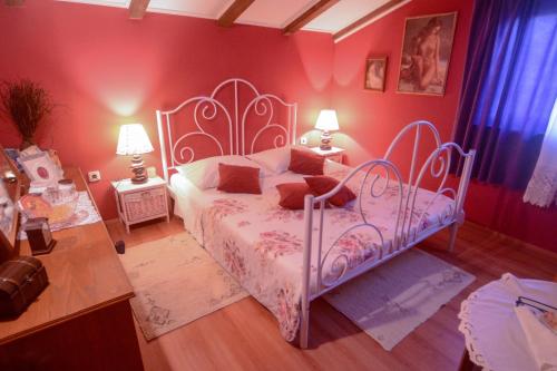 a bedroom with a white bed and red walls at Apartments Martinović in Zaton