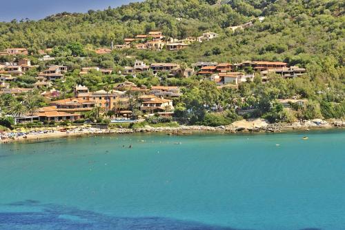 a group of people in the water at a beach at Hotel La Bitta - Bovis Hotels in Àrbatax