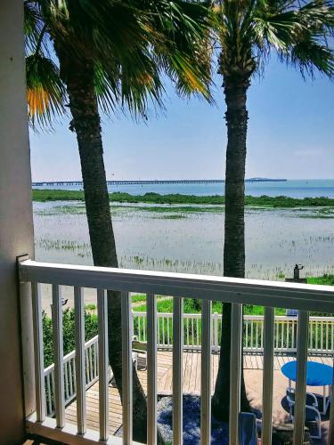 a balcony with a view of the beach at Blue Bay Inn and Suites in South Padre Island