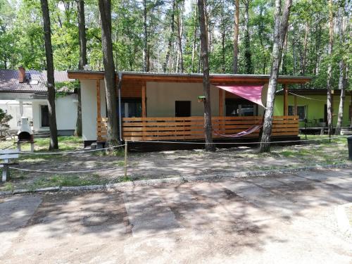 a house with a hammock in front of it at OLEK in Turawa