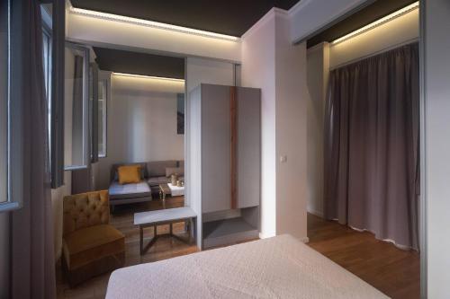a bedroom with a bed and a living room at ATHENIAN YARD SUITES in Athens