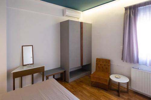a bedroom with a bed and a desk and a chair at ATHENIAN YARD SUITES in Athens