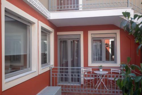 a balcony of a house with a table and chairs at ATHENIAN YARD SUITES in Athens