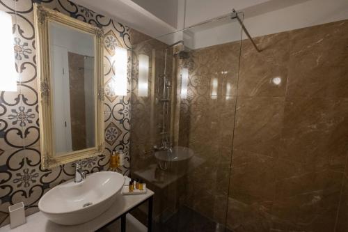 a bathroom with a sink and a shower at ATHENIAN YARD SUITES in Athens