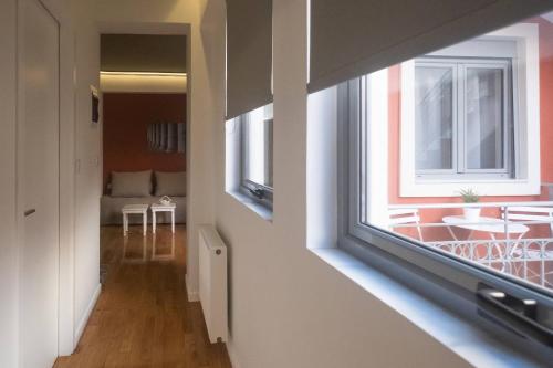 a hallway with a window and a living room at ATHENIAN YARD SUITES in Athens