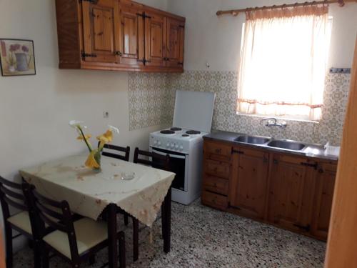 a kitchen with a table and a stove at EMILIOS SEE VIEW in Barbati