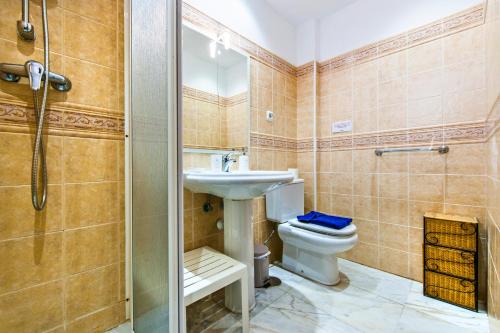 a bathroom with a toilet and a sink and a shower at Apartamento Ocean Vista in El Cotillo