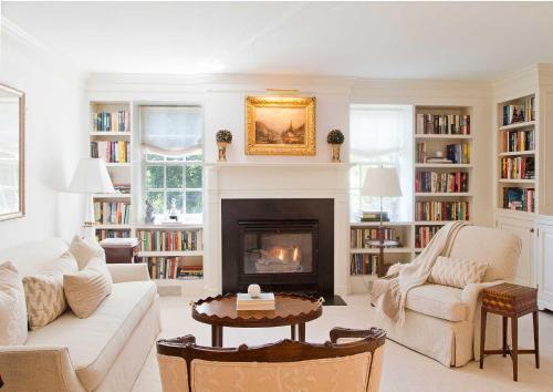 a living room with a couch and a fireplace at The Mayflower Inn & Spa, Auberge Resorts Collection in Washington