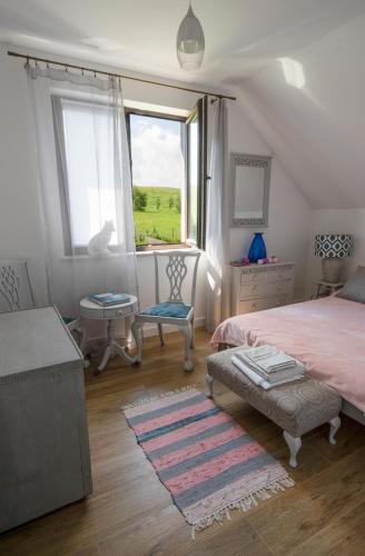 a bedroom with two beds and a large window at Willa Liski in Stare Juchy