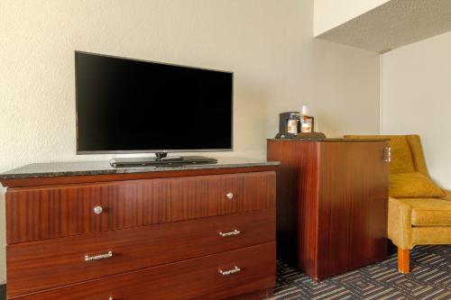 a flat screen tv sitting on top of a dresser at Inn at the Highland Denver Downtown in Denver