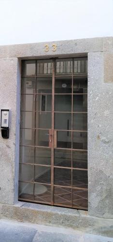 a large glass door in a building at Anjo33 Flats in Braga