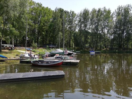 a group of boats docked at a dock in the water at OLEK in Turawa