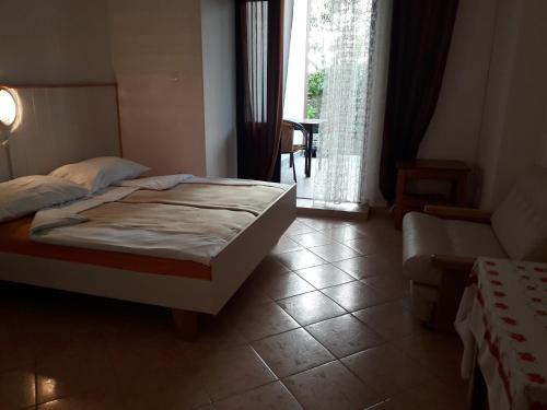 a bedroom with a bed and a large window at Apartmani Ana Novi V. - studio in Novi Vinodolski