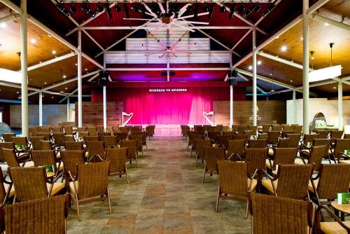 a large room with chairs and a pink curtain at Barceló Bávaro Beach - Adults Only All Inclusive in Punta Cana