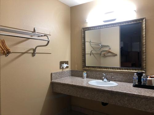 a bathroom with a sink and a mirror at Orange Tustin Inn in Orange in Orange