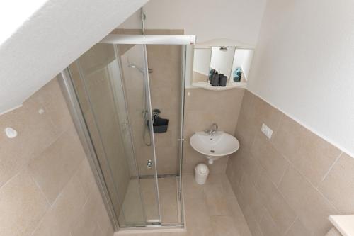 a bathroom with a shower and a sink at Obala in Podgora