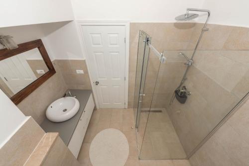 a bathroom with a shower with a glass door at Obala in Podgora