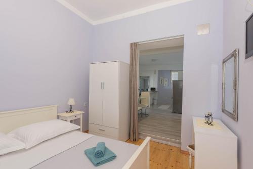 a bedroom with a bed with a blue towel on it at Obala in Podgora