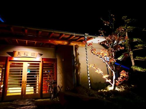 a building with a chinese sign on it at night at Oimatsuen in Saku