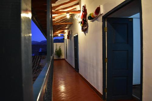 a hallway of a house with a blue door at La Estación San Pedro in Cusco
